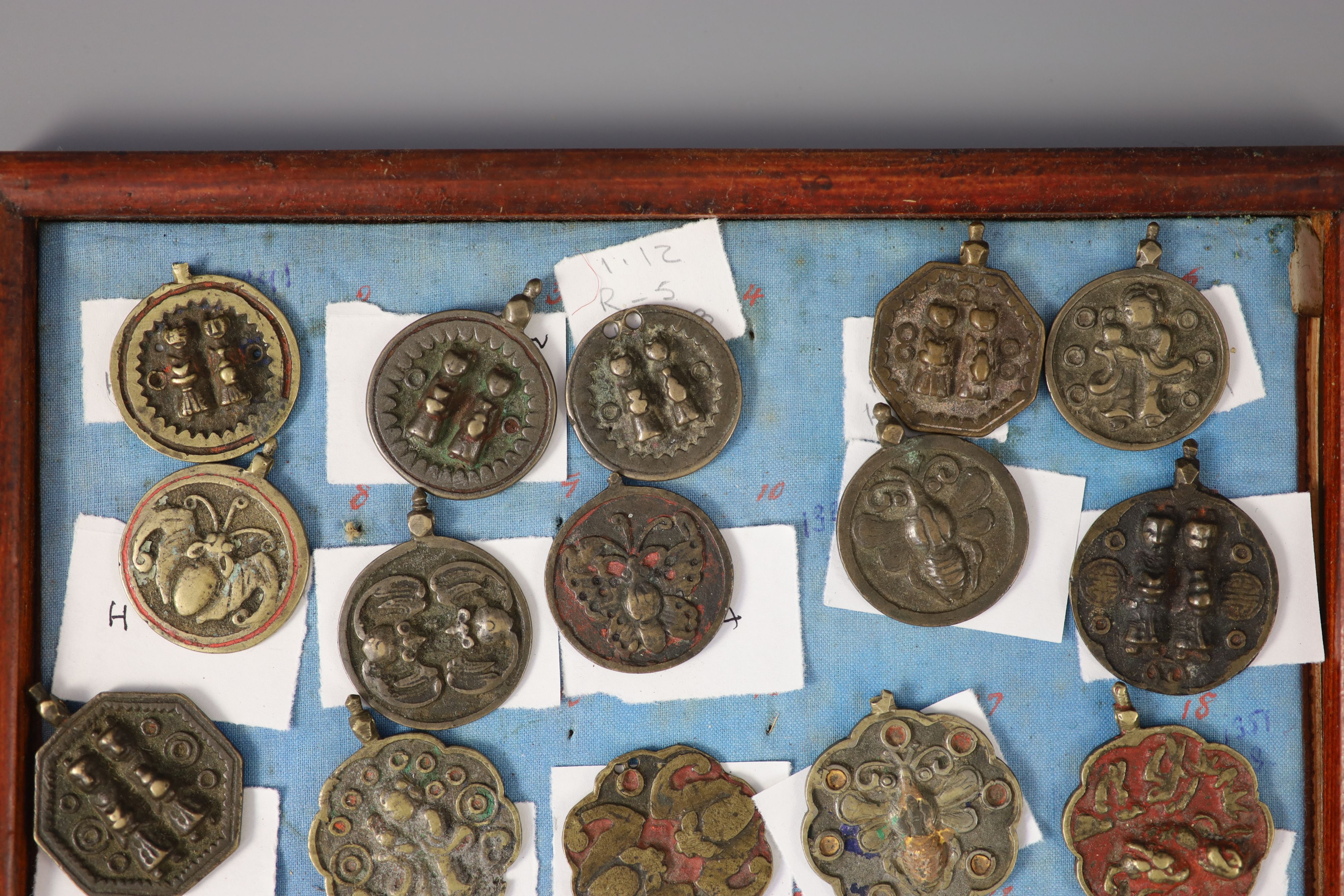A group of 99 Korean bronze and metal amulets or charms, 19th/20th century
